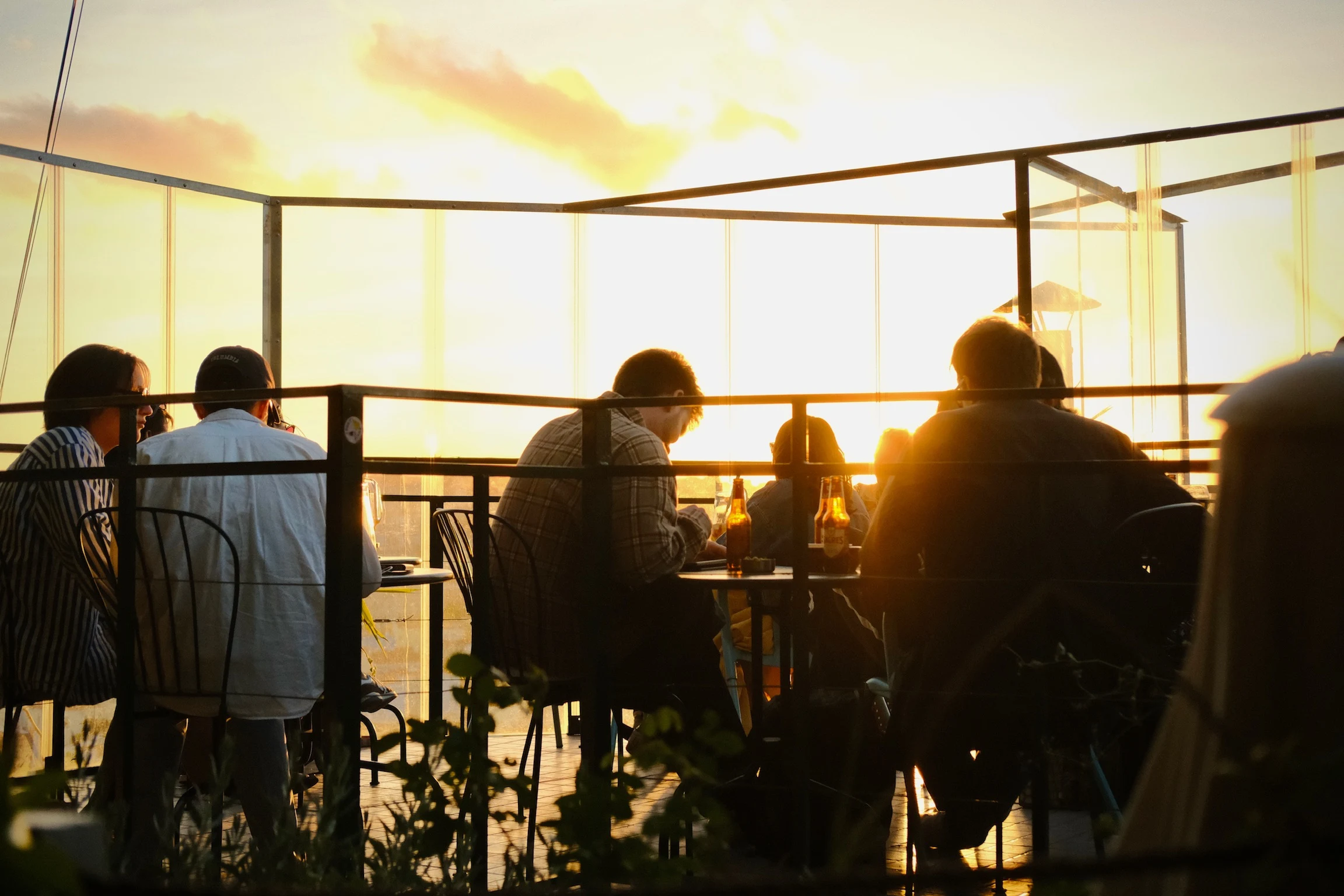 Friends watching the sun set together at a Lisbon terrace
